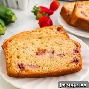 closeup of two slices of strawberry zucchini bread on plate