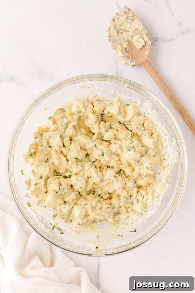 Herbed Egg Salad in a bowl after being mixed, showing its creamy texture.