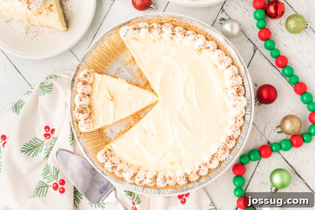 Dreamy No-Bake Eggnog Pie 5 An overhead view of a whole No-Bake Eggnog Pie with a perfect slice already cut out, ready to be served.