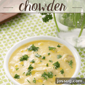 Chicken and Corn Chowder in a white bowl, garnished with fresh herbs.