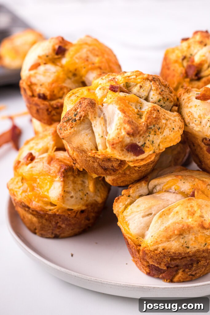 Loaded Bacon Cheddar Ranch Bread 2 baked Cheddar Bacon Ranch Pull-Apart Rolls on plate, ready to be enjoyed