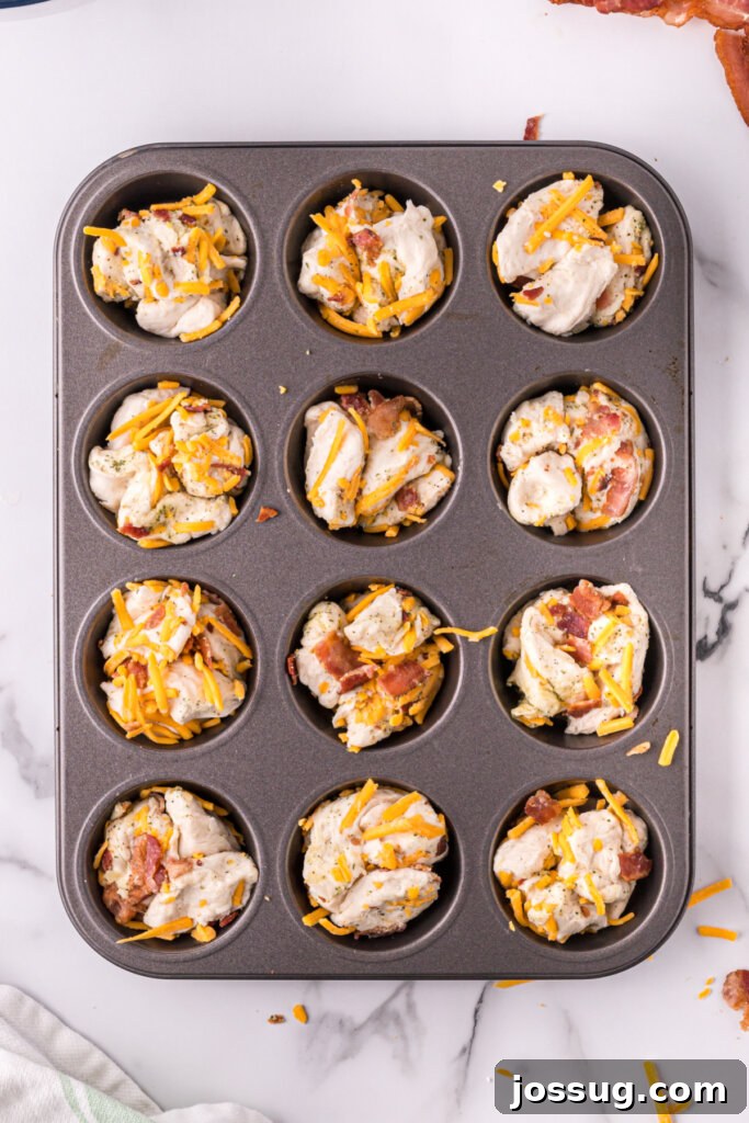 Loaded Bacon Cheddar Ranch Bread 6 cheddar bacon ranch pull apart rolls placed into a muffin tin before being baked