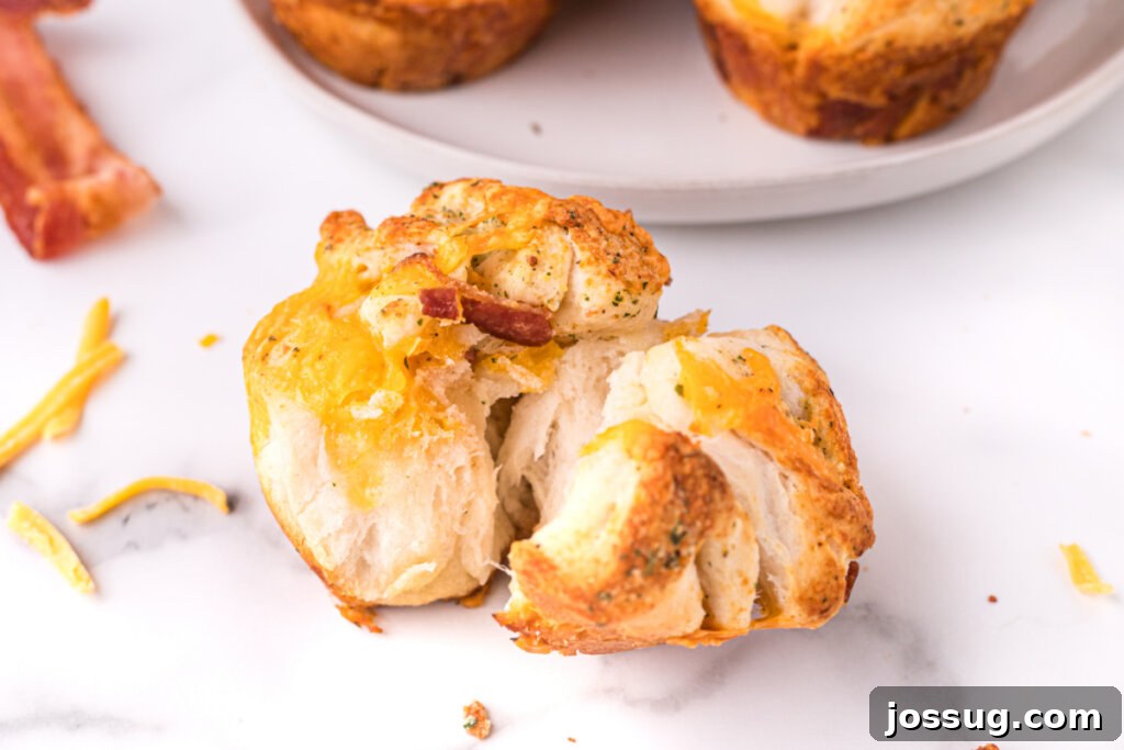 Loaded Bacon Cheddar Ranch Bread 8 close up of a single cheddar bacon ranch pull apart roll, showing the fluffy interior and melted cheese