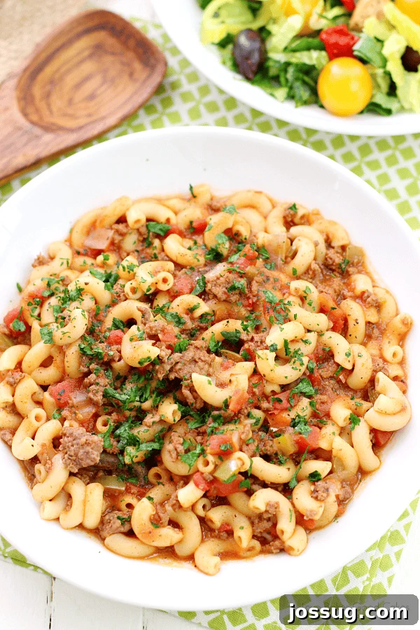 A steaming bowl of hearty One-Pot Goulash with elbow macaroni and ground beef.