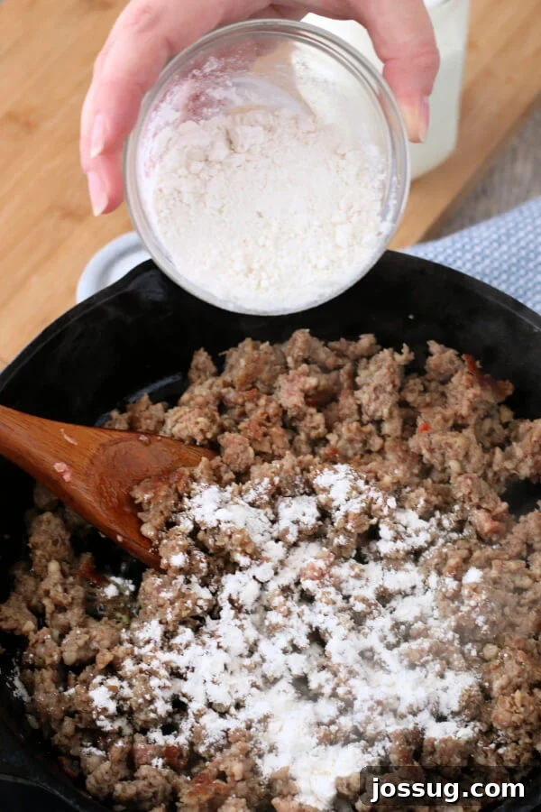 Hearty Homestyle Sausage Gravy 5 Adding flour to the browned and crumbled sausage in a skillet