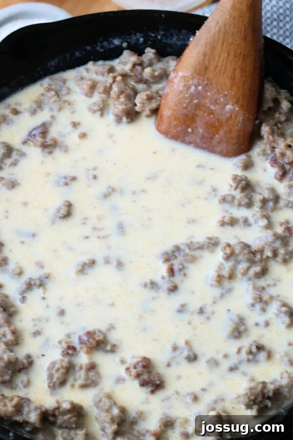 Hearty Homestyle Sausage Gravy 6 Milk being added to the browned sausage and flour mixture for the gravy