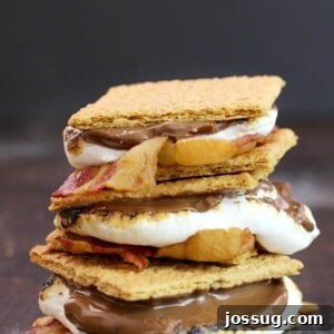 Bacon S'mores stacked up on a cutting board, ready to eat.
