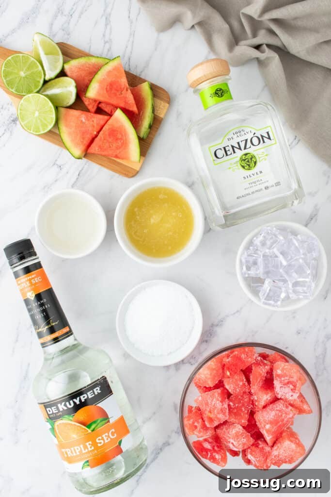 Crimson Wave Margarita 3 Overhead view of ingredients for watermelon margaritas, including a bottle of tequila, triple sec, fresh limes, and a bowl of frozen watermelon chunks on a rustic wooden surface