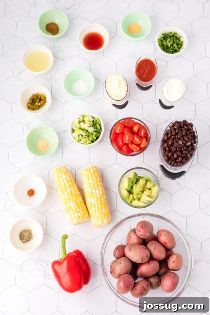 Overhead shot of Southwest Potato Salad ingredients arranged on a white tile background.
