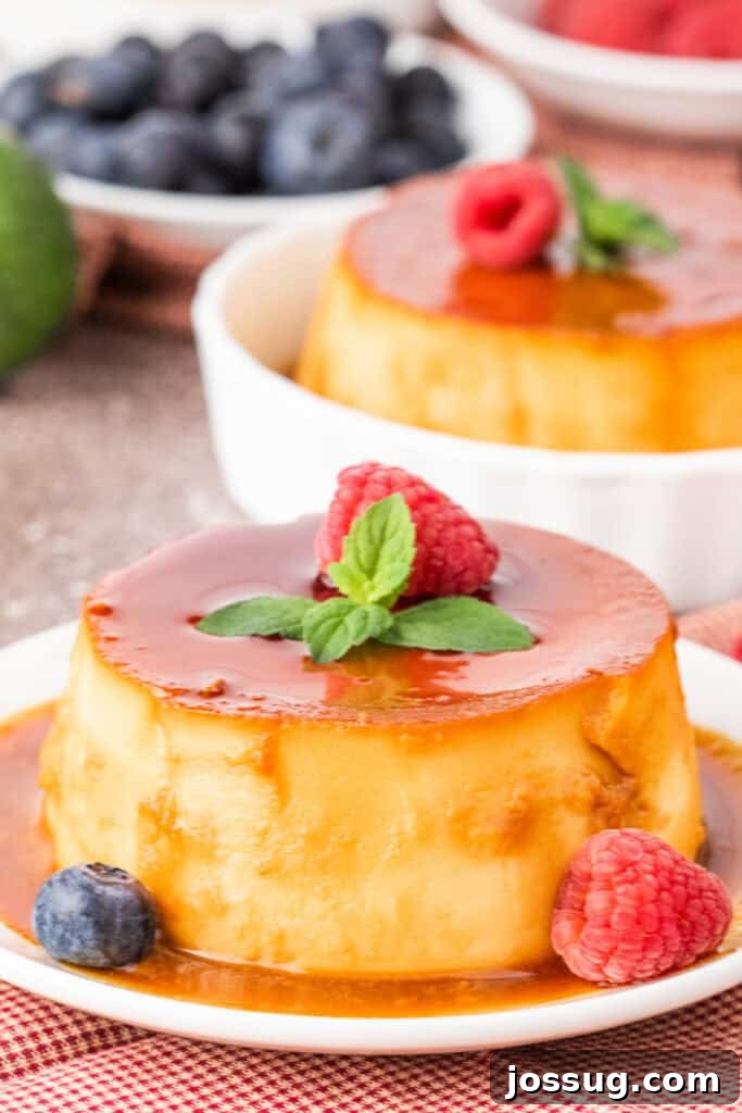 Caramel Flan Bites 2 Mini caramel flan served on a white plate with caramel sauce, garnished with raspberry and mint.