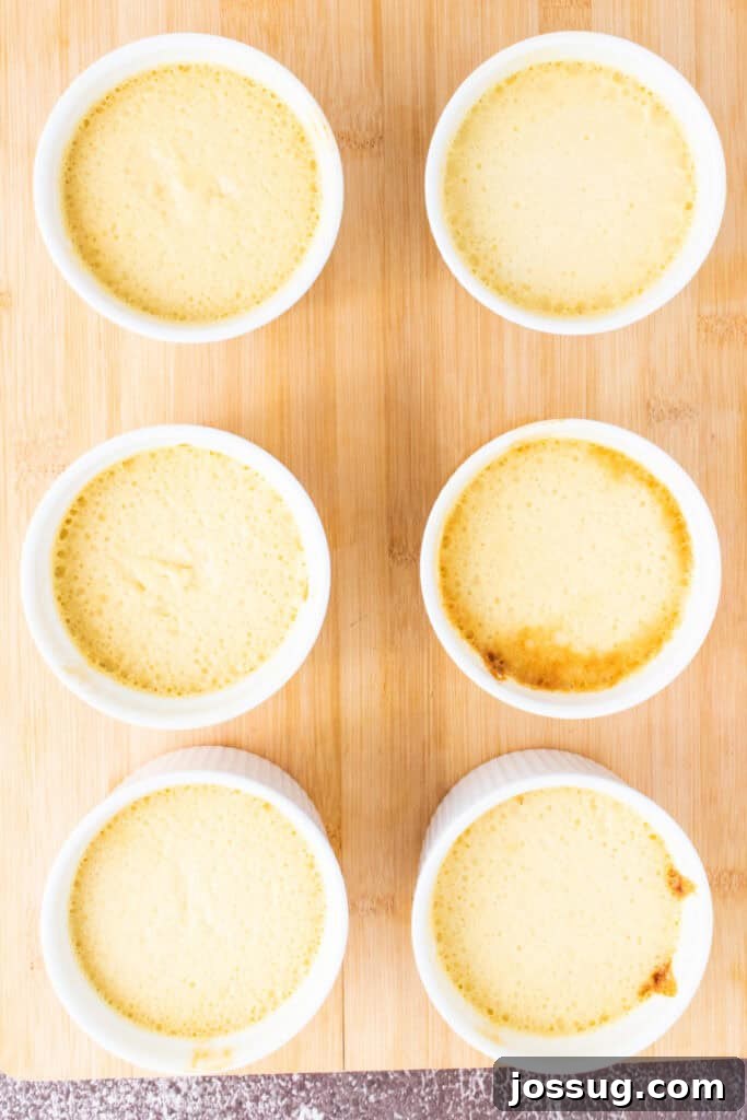 Caramel Flan Bites 10 Six ramekins of baked flan placed on a wooden board, ready for serving or unmolding.