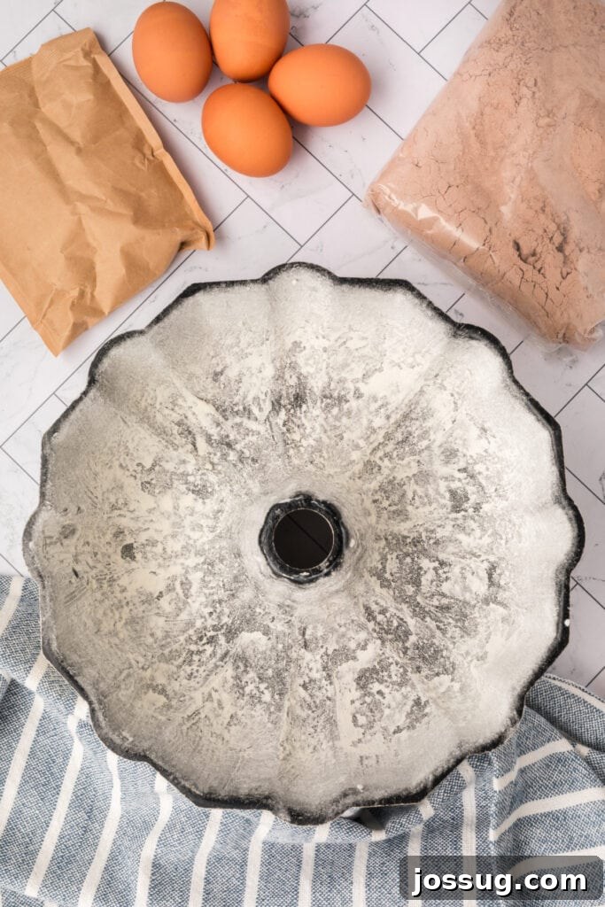 Decadent Kahlua Chocolate Bundt 5 A meticulously greased and floured Bundt pan stands ready, with all the essential KahlĂșa cake ingredients neatly arranged in the background, signaling the start of the baking process.