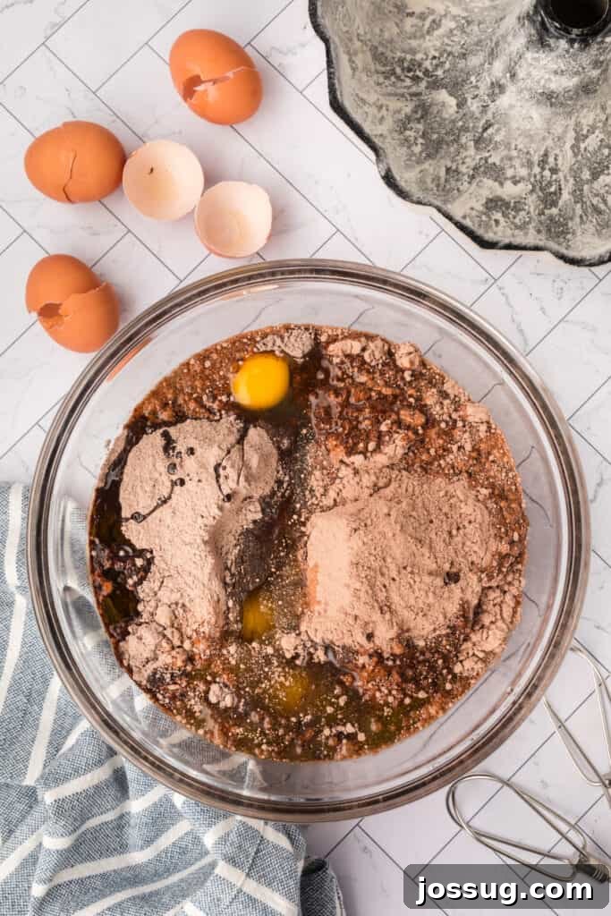 Decadent Kahlua Chocolate Bundt 6 All dry and wet ingredients for the KahlĂșa cake are carefully combined in a spacious glass mixing bowl, poised for thorough mixing into a smooth batter.