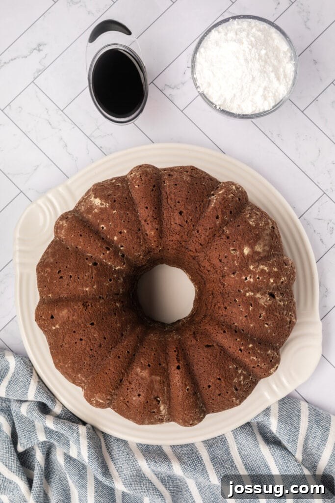 Decadent Kahlua Chocolate Bundt 10 The exquisite Chocolate KahlĂșa Bundt cake, flawlessly inverted from its pan, now rests elegantly on a pristine serving platter, awaiting its finishing touches.