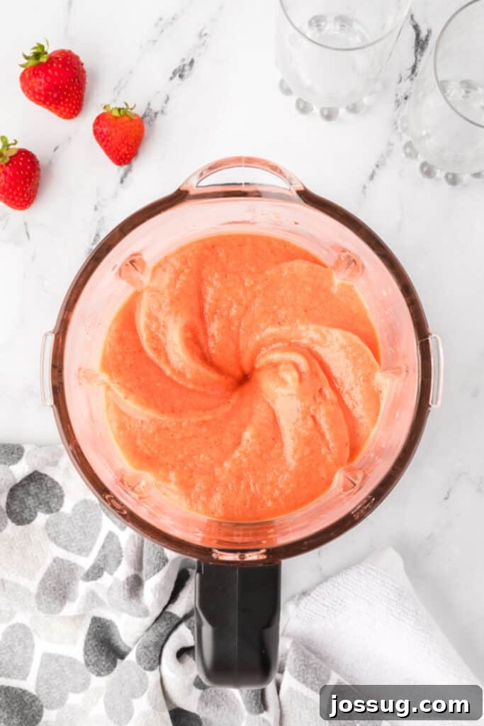 Tropical Ombre Smoothie 5 Blended sunrise sunset smoothie mixture in a blender, perfectly smooth and ready to be served.
