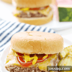 Easy Beef Slider on a white plate with sliced pickles.