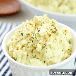 Old-Fashioned Potato Salad in a white bowl, close-up.