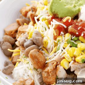 Homemade Burrito Bowl in white bowl, showcasing the delicious layers of rice, chicken, and fresh toppings.
