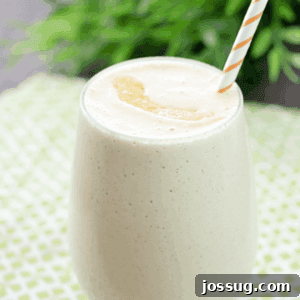 Peach & Oatmeal Smoothie in a glass with a straw.
