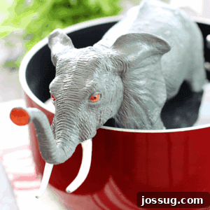 Pachyderm's Pot 3 A small plastic elephant in a cooking pot, humorously depicting the Elephant Stew recipe ready to feed a massive gathering.