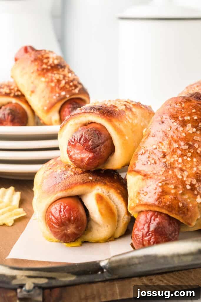 Homemade Pretzel Dogs in a Snap 4 A platter of freshly baked pretzel dogs, sprinkled with coarse salt, arranged for serving.
