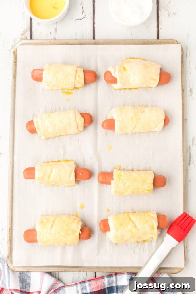 Homemade Pretzel Dogs in a Snap 9 Pretzel dogs brushed with egg wash and sprinkled with coarse salt.