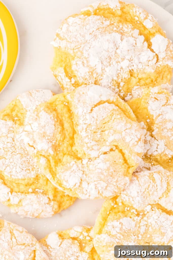 Sunshine Lemon Crinkles 5 A close-up view of multiple Lemon Crinkle Cookies artfully arranged on a platter, ready to be served.