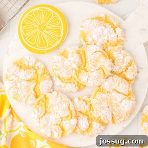 A plate generously filled with golden Lemon Crinkle Cookies, showcasing their delightful texture and vibrant color.