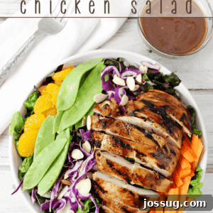 Asian Chicken Salad in a white bowl with a fork, ready to eat.
