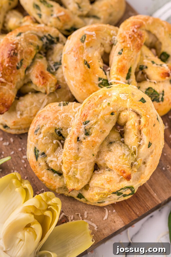Savory Spinach Artichoke Pretzels 4 Close-up view of freshly baked Spinach Artichoke Pretzels, showcasing the golden crust and filling