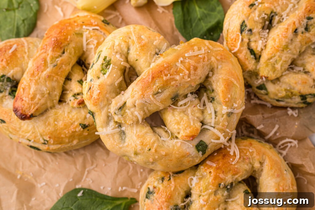 Savory Spinach Artichoke Pretzels 5 A batch of baked Spinach Artichoke Pretzels cooling on brown paper, ready to be served