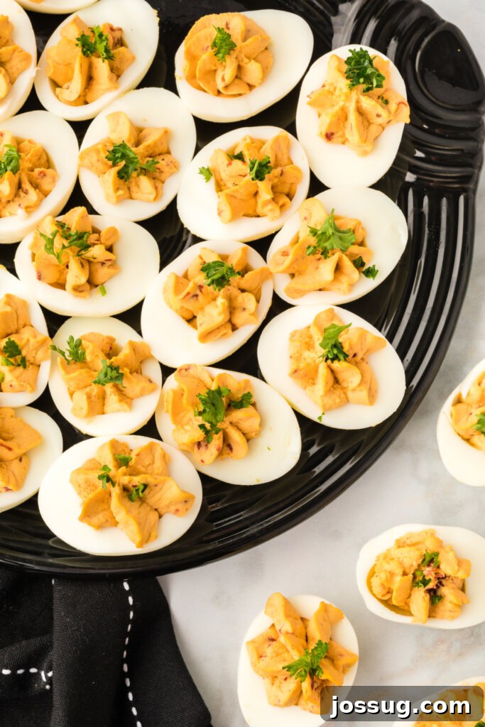 Smoky Chipotle Deviled Eggs 4 chipotle deviled eggs on black platter