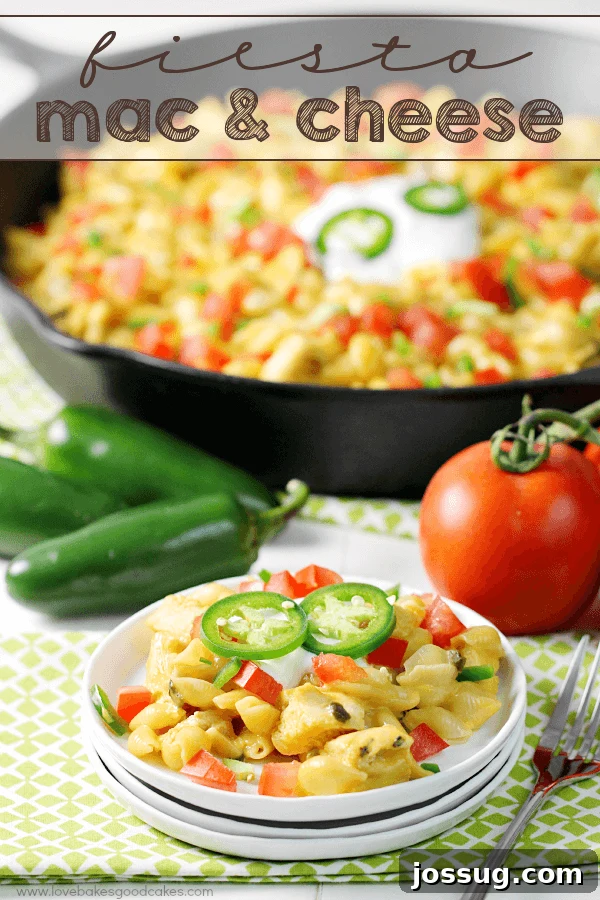 Zesty Fiesta Mac 2 A vibrant Fiesta Mac & Cheese dish served on a white plate, with a rustic skillet and fresh vegetables like tomatoes and jalapeños in the background, suggesting a quick and easy preparation.