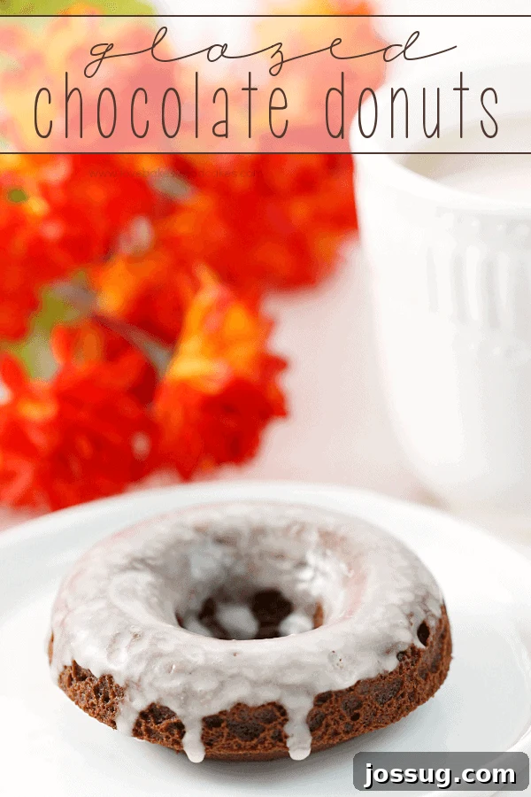 Decadent Chocolate Glazed Delights 2 Delicious Glazed Chocolate Donuts perfectly arranged on a crisp white plate, ready to be enjoyed with a cup of coffee.