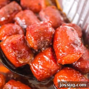 Close-up of caramelized hot dog burnt ends in BBQ sauce, scooped from the pan