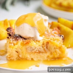 Square-cropped image of Piña Colada Bread Pudding with vanilla ice cream and golden sauce