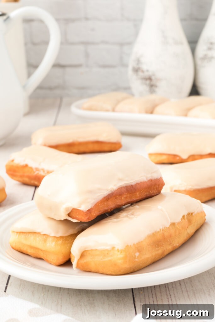 Golden Maple Treats 4 Three perfectly glazed maple bars stacked on a plate, tempting with their sweet coating.