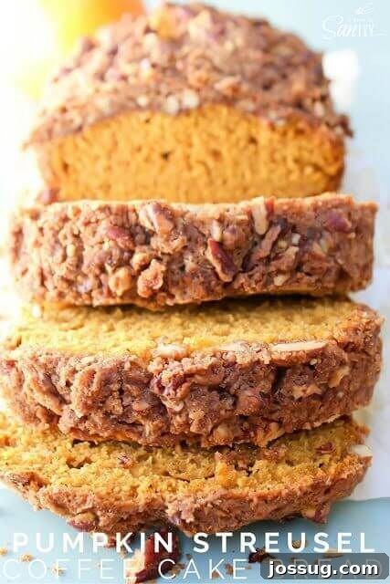 Pumpkin Streusel Coffee Loaf 3 A freshly baked loaf of Pumpkin Streusel Coffee Cake Bread, perfectly sliced to reveal its moist interior and generous, golden streusel topping.