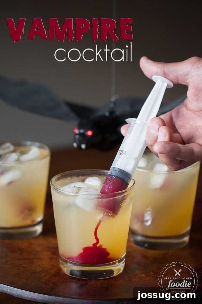 A dramatic Vampire Cocktail, with red liquid being injected from a syringe into a glass, creating a blood-like effect.