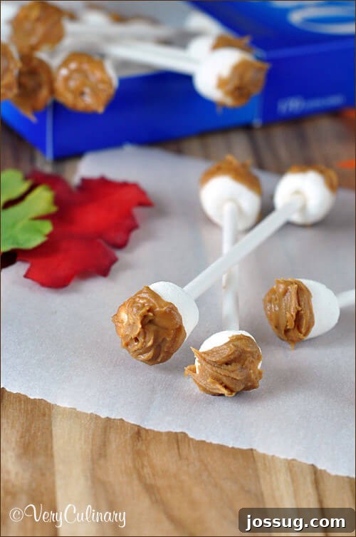 Playfully gross edible earwax on cotton swabs, made from candy, arranged on wax paper.