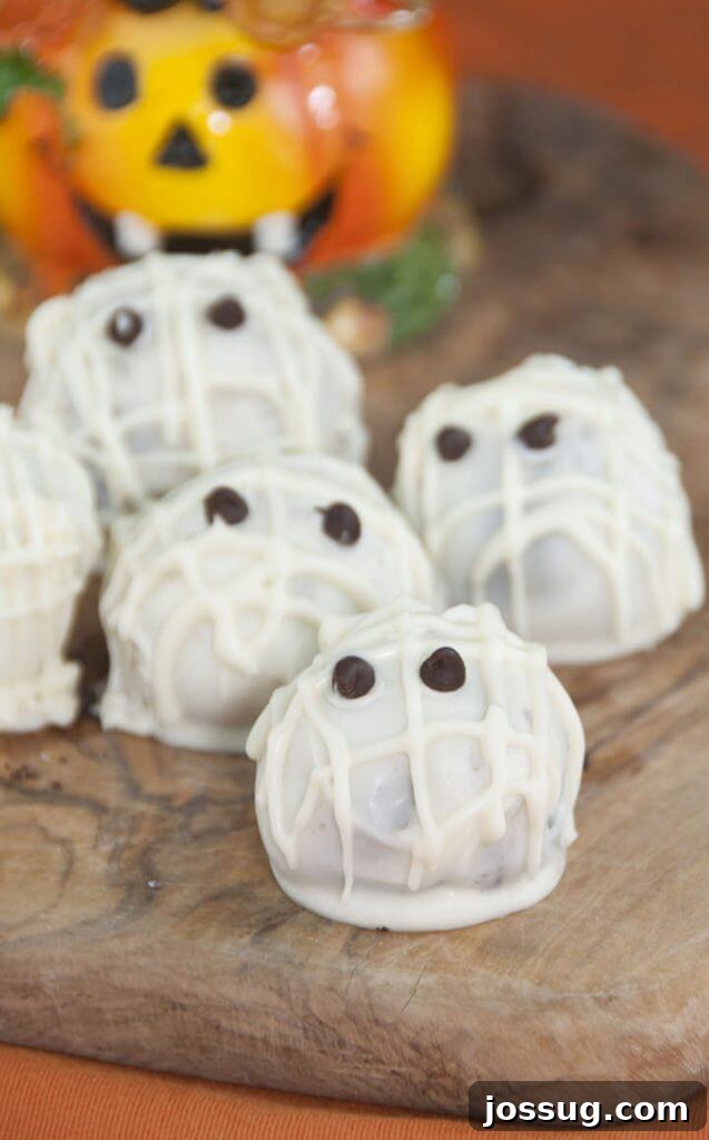 Halloween Mummy Oreo Truffles, intricately decorated with white chocolate 'bandages' and edible eyes.