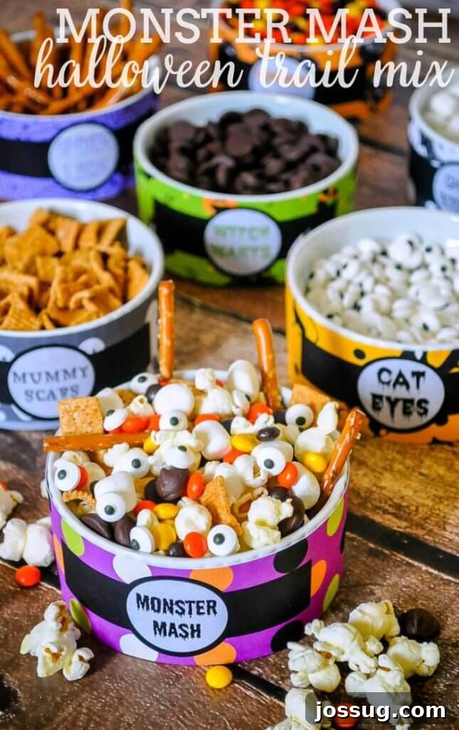 A colorful and varied Monster Mash Halloween Trail Mix, featuring candies, pretzels, and other festive snacks.