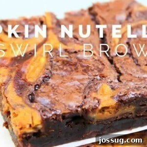 Pumpkin Nutella Swirl Brownies freshly baked and stacked on a plate.