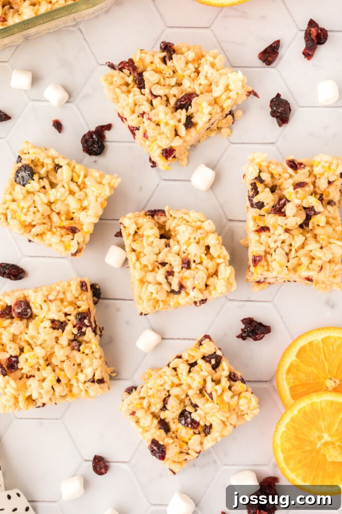 Sunshine Berry Crunch Bars 4 raw ingredients for rice krispie treats on a table, including marshmallows, cereal, butter, and cranberries