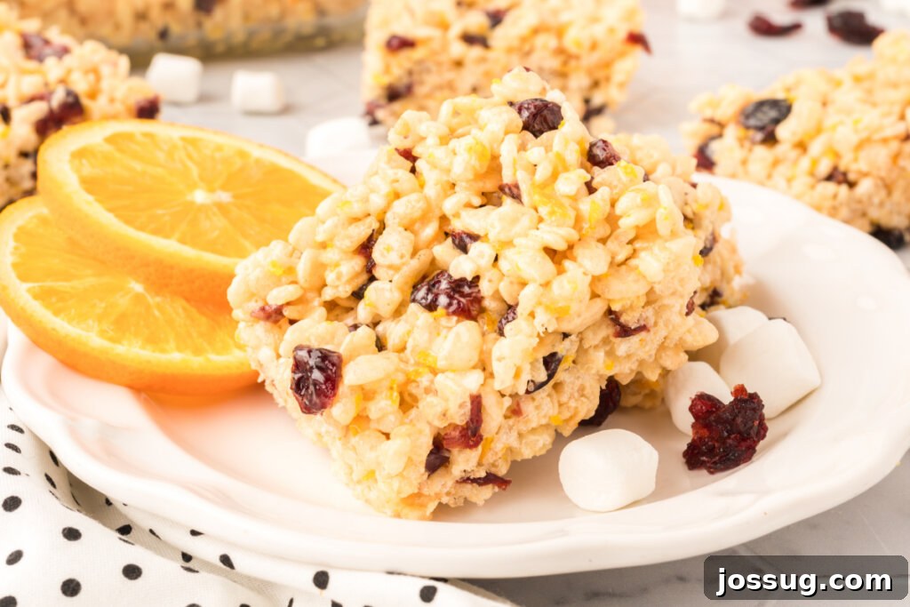 Sunshine Berry Crunch Bars 6 pile of cranberry orange rice crispy treats on a plate, ready to be enjoyed
