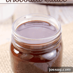 A charming glass jar filled with rich, dark homemade chocolate sauce, ready for serving.