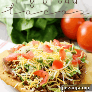 Fry Bread Taco on a white plate with fresh vegetables.