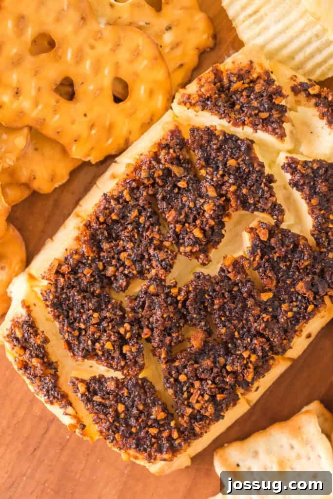 Smoked cream cheese served on a wooden board with pretzel thins and chips