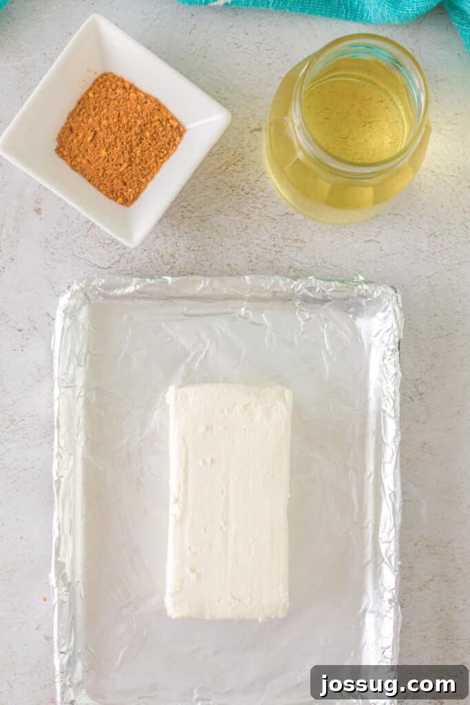Overhead view of cream cheese, olive oil, and BBQ seasoning on a prep tray