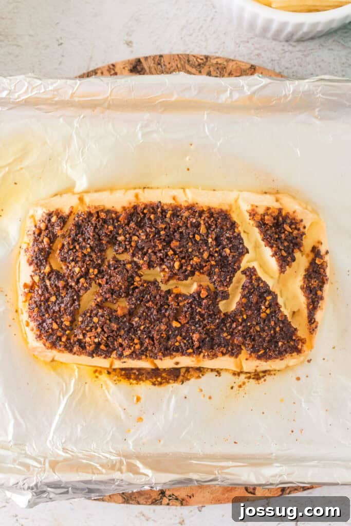 Smoked cream cheese fully cooked with a crispy top layer on foil